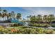 Community pool and waterslide at the Estrella community in Goodyear, Arizona surrounded by palm trees and beautiful flowers at 15899 S 183Rd Dr, Goodyear, AZ 85338
