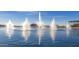 Scenic fountains on the lake surrounded by lush landscaping and beautiful mountain views at Estrella in Goodyear, Arizona at 15899 S 183Rd Dr, Goodyear, AZ 85338