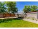 Fenced backyard with healthy green grass, block wall, and a shade tree at 1617 W Vineyard Rd, Phoenix, AZ 85041