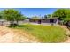 Large backyard features a well-maintained lawn and block fencing for privacy at 1617 W Vineyard Rd, Phoenix, AZ 85041
