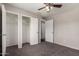 Bedroom featuring carpet, ceiling fan, closet and bright window at 1617 W Vineyard Rd, Phoenix, AZ 85041