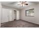 Carpeted bedroom featuring double closets, neutral paint, and bright window at 1617 W Vineyard Rd, Phoenix, AZ 85041