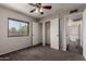 Bedroom with closets, carpet, neutral walls, and view into kitchen at 1617 W Vineyard Rd, Phoenix, AZ 85041