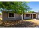 Single-story house with a carport, offering a glimpse of the backyard through its classic window design at 1617 W Vineyard Rd, Phoenix, AZ 85041
