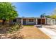 Charming single-story home with a well-kept yard and a convenient carport under a clear, blue sky at 1617 W Vineyard Rd, Phoenix, AZ 85041