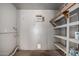 Utility garage features shelving, drywall, and a window AC unit at 1617 W Vineyard Rd, Phoenix, AZ 85041