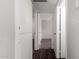 Hallway shows multiple doorways leading to carpeted rooms at 1617 W Vineyard Rd, Phoenix, AZ 85041