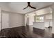 Inviting living area with dark wood floors, neutral walls, ceiling fan, and an open view to the kitchen at 1617 W Vineyard Rd, Phoenix, AZ 85041