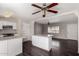 Open concept living room and kitchen with ceiling fan and wood-look flooring at 1617 W Vineyard Rd, Phoenix, AZ 85041