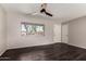 Inviting living room featuring modern dark wood floors and a large window for ample natural light at 1617 W Vineyard Rd, Phoenix, AZ 85041