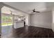 Open-concept living area featuring modern dark wood floors, neutral paint, and an adjacent kitchen with an island at 1617 W Vineyard Rd, Phoenix, AZ 85041