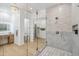 Elegant bathroom with glass enclosed shower, chandelier, and custom vanity with storage at 16389 N 108Th Pl, Scottsdale, AZ 85255