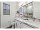 Stylish bathroom featuring double sinks with marble countertops and framed mirror at 16389 N 108Th Pl, Scottsdale, AZ 85255