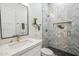 Clean bathroom with a modern sink and shower, herringbone tiled wall and geometric floor at 16389 N 108Th Pl, Scottsdale, AZ 85255