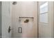 Modern shower with a niche, rainfall showerhead, and sleek glass enclosure at 16389 N 108Th Pl, Scottsdale, AZ 85255