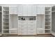 Spacious walk-in closet with custom shelving, drawers, and ample storage solutions at 16389 N 108Th Pl, Scottsdale, AZ 85255