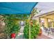 Tranquil backyard featuring a grape covered walkway and colorful plants, providing a serene and private outdoor space at 17374 W Adams St, Goodyear, AZ 85338