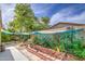 Secluded backyard oasis with a waterfall feature, decorative wall art, and privacy screening for a peaceful outdoor retreat at 17374 W Adams St, Goodyear, AZ 85338