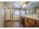 A well-lit bathroom features a walk-in shower, soaking tub, and sink at 17374 W Adams St, Goodyear, AZ 85338