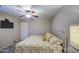 This bedroom features a cozy bed with decorative pillows and a ceiling fan at 17374 W Adams St, Goodyear, AZ 85338