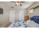 This bedroom includes a ceiling fan, two doors, and a cozy bed at 17374 W Adams St, Goodyear, AZ 85338