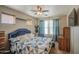 Bright bedroom with a bed, windows with curtains, and a ceiling fan at 17374 W Adams St, Goodyear, AZ 85338