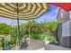 Charming courtyard area with multiple seating areas under shade covers, potted plants and an enchanting garden at 17374 W Adams St, Goodyear, AZ 85338