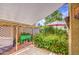 Charming courtyard featuring a shade cover, lush flowering plants, decorative pots, and a grilling area for outdoor enjoyment at 17374 W Adams St, Goodyear, AZ 85338