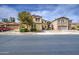 Front of two-story home with landscaping and trees on a sunny day with blue skies at 17374 W Adams St, Goodyear, AZ 85338