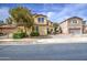 Exterior view of a two-story home with trees, landscaping, and blue skies at 17374 W Adams St, Goodyear, AZ 85338