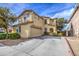 Front view of two-story home with landscaping, garage, and driveway on a sunny day at 17374 W Adams St, Goodyear, AZ 85338