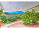 Lush garden with mature greenery, brick-lined pathways, and shade canopies for a serene outdoor escape at 17374 W Adams St, Goodyear, AZ 85338