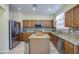 Modern kitchen featuring stainless steel appliances, granite counters and central island at 17374 W Adams St, Goodyear, AZ 85338