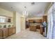 Bright kitchen featuring wooden cabinets, granite countertops, and modern appliances at 17374 W Adams St, Goodyear, AZ 85338