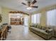 Open-concept living room flowing into the kitchen, featuring tile floors and bright, natural light at 17374 W Adams St, Goodyear, AZ 85338