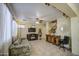 Comfortable living room with tile floors, fireplace, TV, and sofa with floral accents at 17374 W Adams St, Goodyear, AZ 85338