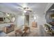 Bright living room boasts neutral paint, ceiling fan and natural light at 17374 W Adams St, Goodyear, AZ 85338