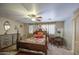 Spacious primary bedroom with a ceiling fan, and a well-lit desk at 17374 W Adams St, Goodyear, AZ 85338