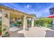 Inviting covered patio features decorative pillars, colorful decor, garden views, and comfortable seating for relaxing and entertaining at 17374 W Adams St, Goodyear, AZ 85338