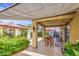 Spacious covered patio showcasing tile flooring, dining furniture, colorful lighting, and a serene garden view for outdoor living at 17374 W Adams St, Goodyear, AZ 85338