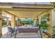 Covered patio includes outdoor swing seating and plants, creating a peaceful and inviting space to enjoy the backyard at 17374 W Adams St, Goodyear, AZ 85338