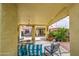 Relaxing covered patio featuring stylish outdoor furniture and decorative lighting for tranquil evenings at 17374 W Adams St, Goodyear, AZ 85338