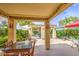 Inviting covered patio featuring tile flooring, colorful decor, outdoor seating and garden views for relaxing and entertaining at 17374 W Adams St, Goodyear, AZ 85338