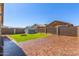 Backyard featuring expansive brick patio, green grass, block fencing, and shed at 18008 W Tina Ln, Surprise, AZ 85387