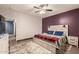 Comfortable bedroom features a bed with decorative headboard, plush carpet, and ample natural light at 18008 W Tina Ln, Surprise, AZ 85387