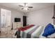 A well-lit bedroom with dresser, TV, and access to ensuite bathroom, creating a comfortable private space at 18008 W Tina Ln, Surprise, AZ 85387