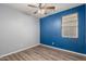 Bedroom features modern ceiling fan, sleek flooring, and two tone paint at 18008 W Tina Ln, Surprise, AZ 85387