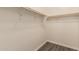 Clean, walk-in closet featuring wood-look flooring and white paint at 18008 W Tina Ln, Surprise, AZ 85387