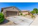 Well-maintained property featuring desert landscaping and a spacious driveway leading to the welcoming facade at 18008 W Tina Ln, Surprise, AZ 85387
