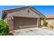 Well-maintained single-story home shows desert landscaping in the front yard and an attached garage at 18008 W Tina Ln, Surprise, AZ 85387